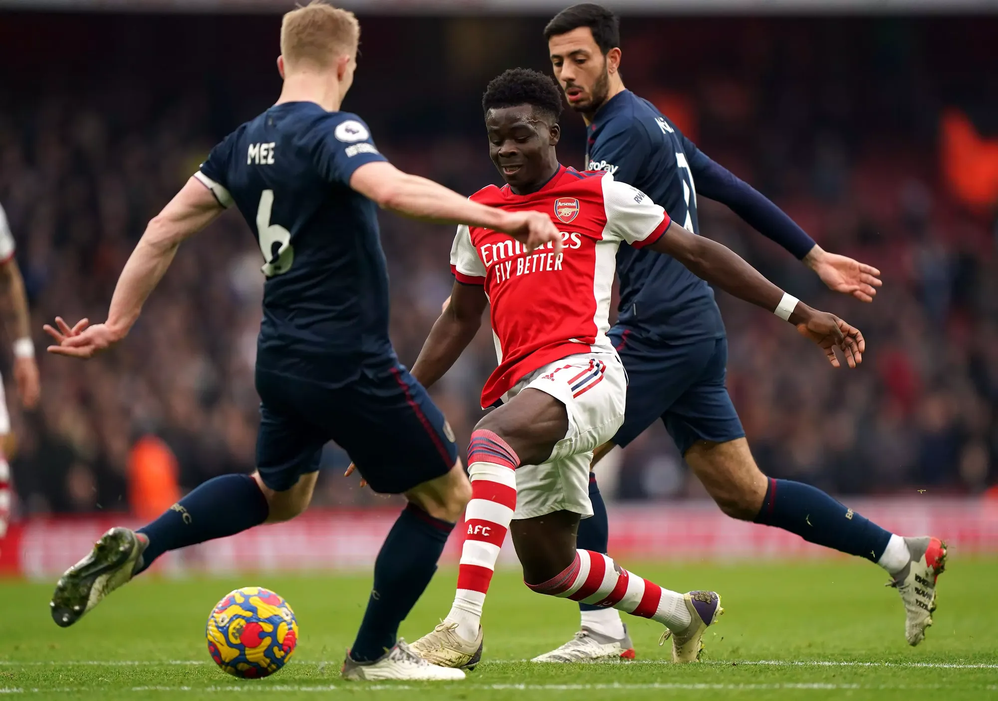 Arsenal's Bukayo Saka takes on Burnley captain Ben Mee