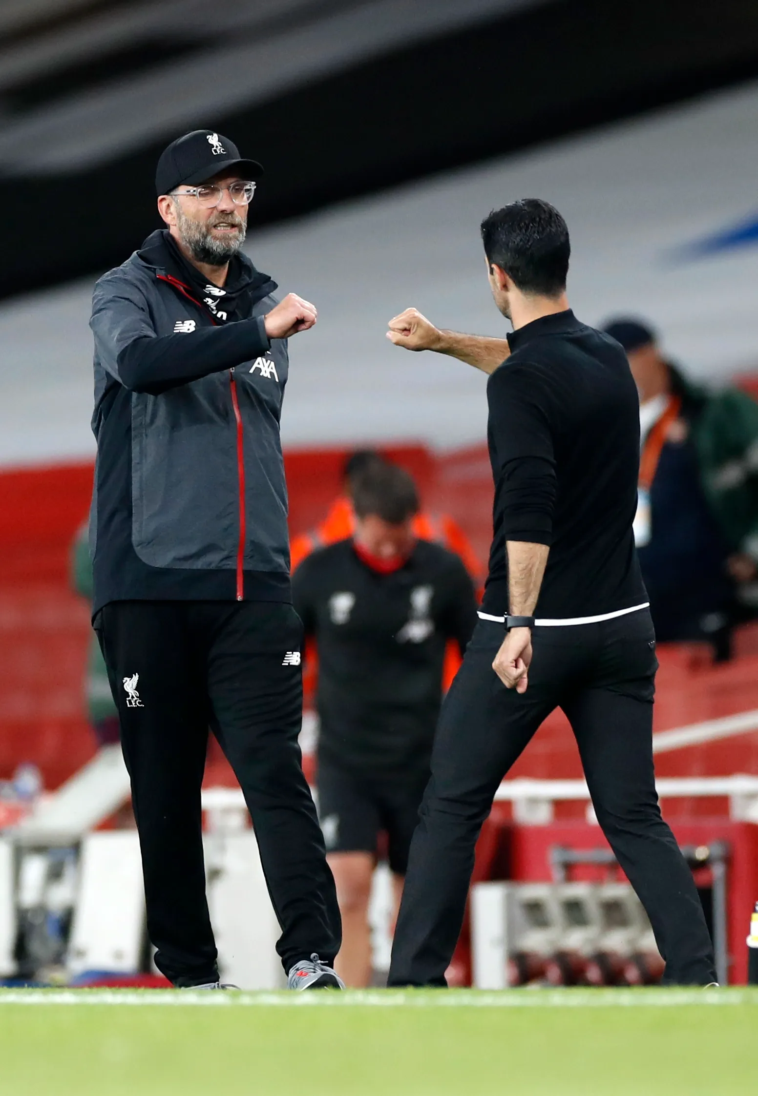 Jurgen Klopp and Mikel Arteta bump fists at the end of the Caraboa Cup first-leg