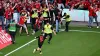 Leverkusen’s Florian Wirtz calms down fans and security personnel as he celebrates after scoring his side’s fourth goal (Dav