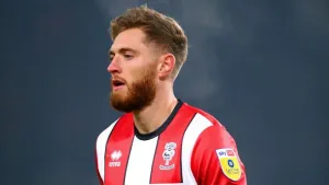 Lincoln move up to fourth with victory over 10-man Blackpool