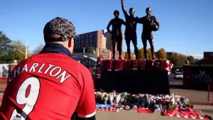 Tributes were laid in memory of Sir Bobby Charlton by the United Trinity statue at Old Trafford (Barrington Coombs/PA)