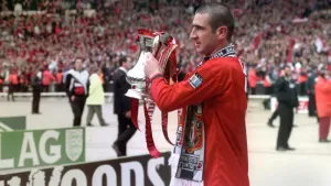 Eric Cantona, lifting the FA Cup, won the competition twice and four Premier League titles with United (PA)