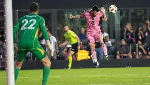 Inter Miami forward Lionel Messi, right, heads the ball as Atlanta United goalkeeper Josh Cohen (22) watches during the firs