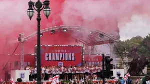 Red and white smoke fills the air as England’s players celebrate on stage (Gareth Fuller/PA)