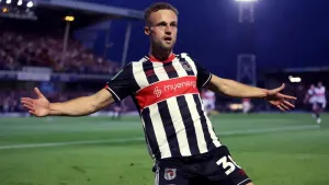 Grimsby hang on after 10-man MK Dons stage second-half fightback