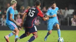 Inter Miami forward Lionel Messi, right, controls the ball as New England Revolution midfielder Brandon Bye (15) and Inter M