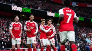Martin Odegaard (third left) celebrates opening the scoring as Arsenal beat Brighton 2-1 to stay top of the Premier League (