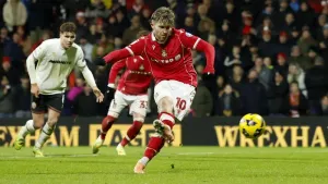 Wrexham’s Josh Windass scores his side’s fifth goal (PA)