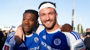 Macclesfield goal heroes Paul Dawson, right, and Isaac Buckley-Ricketts celebrate their famous FA Cup third round over holde