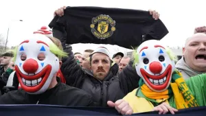 Manchester United fans wore clown masks holding banners during the pre-match protest (Peter Byrne/PA)